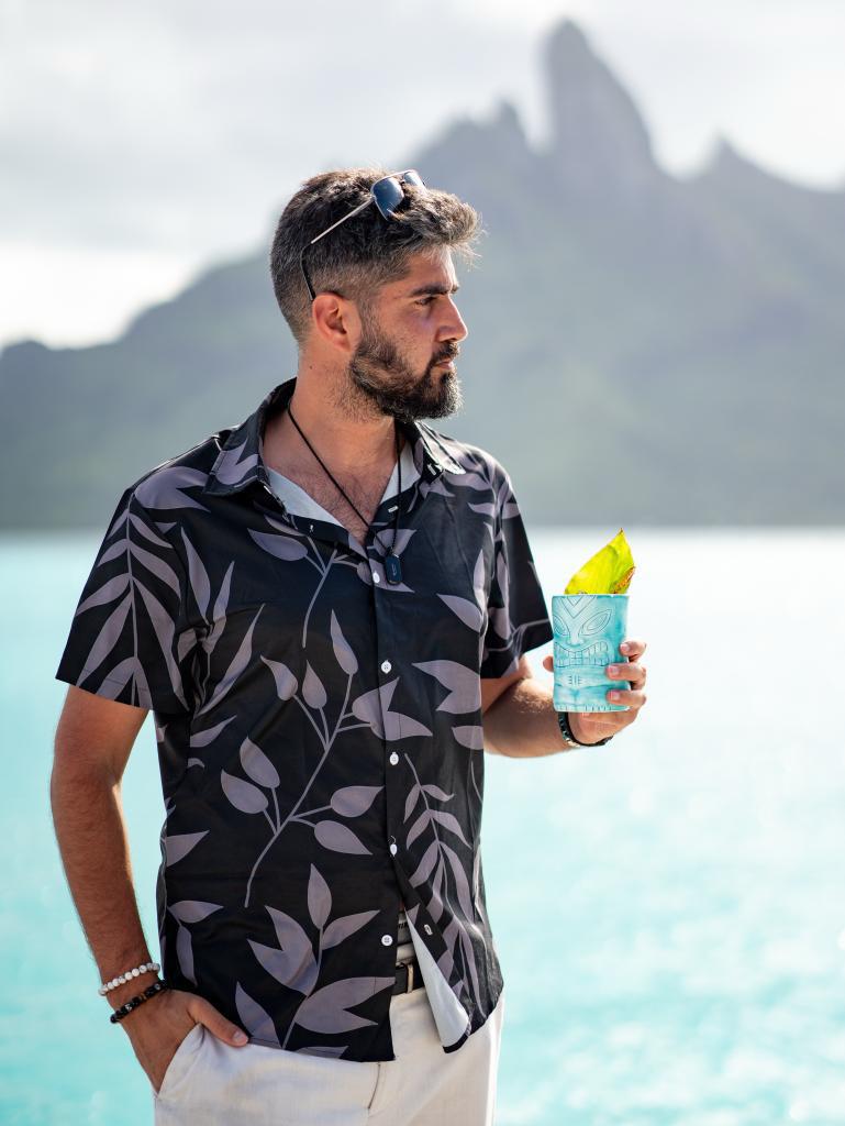 Alex Black with a tropical drink in Bora Bora